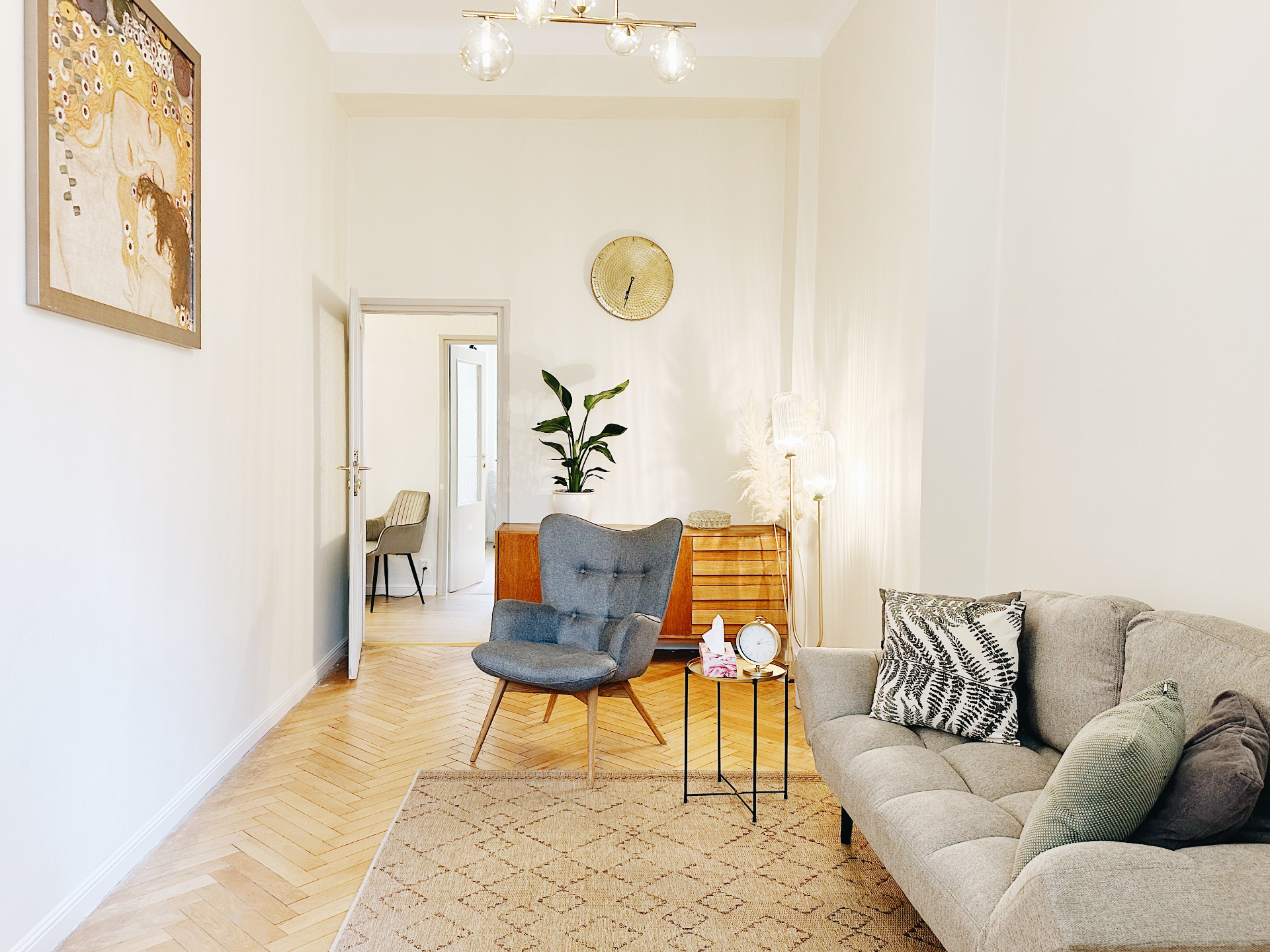 Liberté office - a lounge with an armchair, sofa and herringbone parquet floor